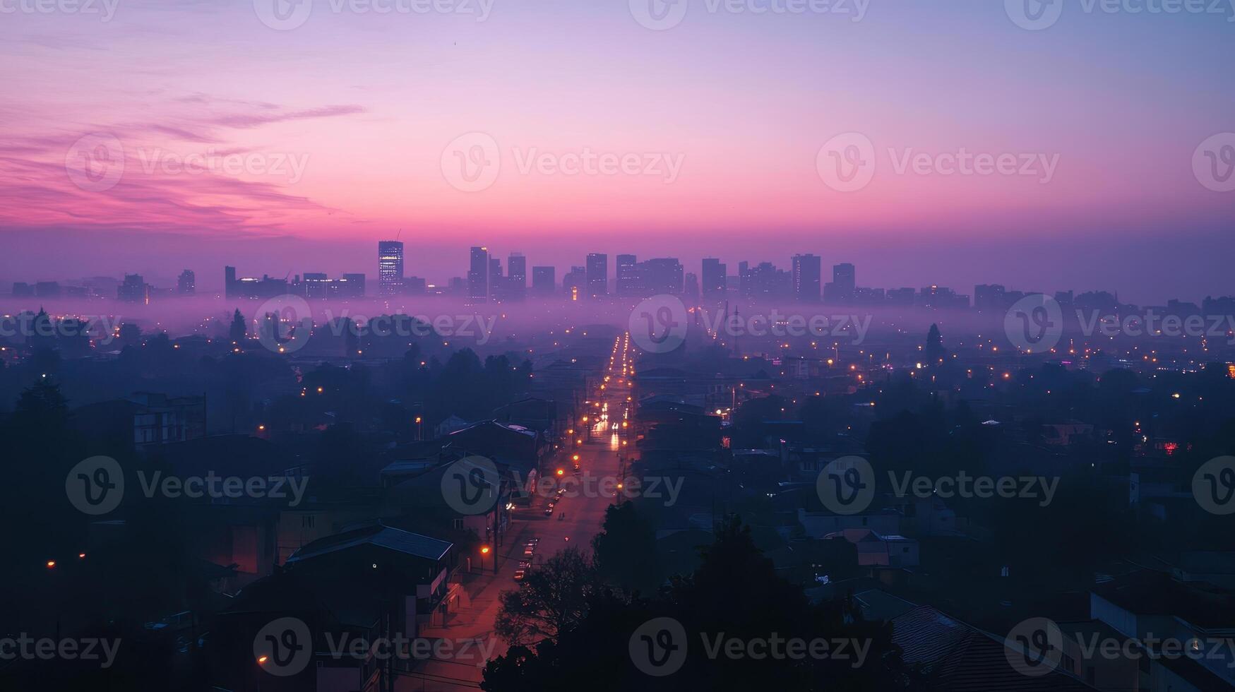 A serene cityscape at dawn with fog and streetlights illuminating the path photo