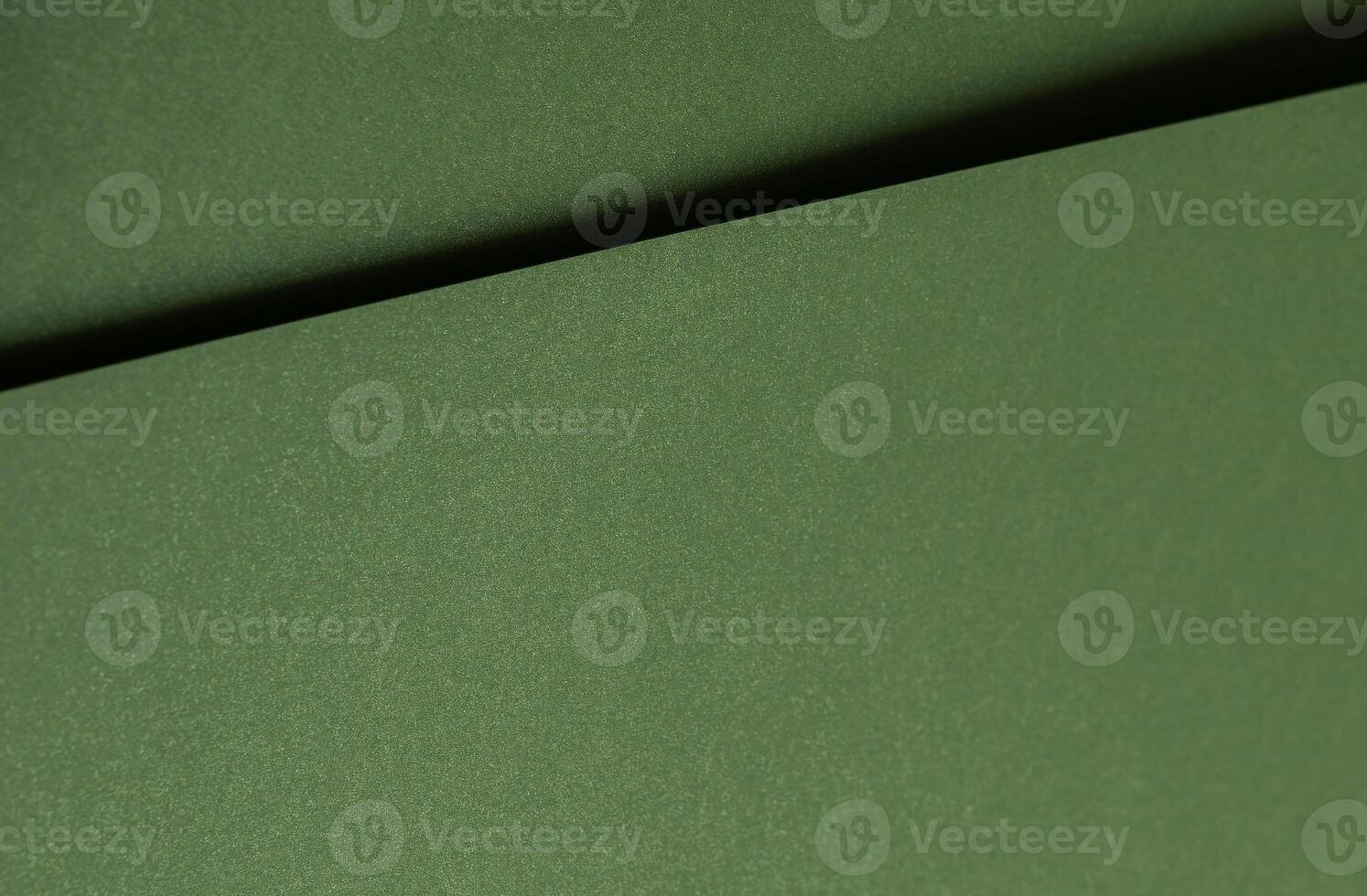 Moss green paper background with a smooth matte texture and subtle geometric lines. Deep forest and photo