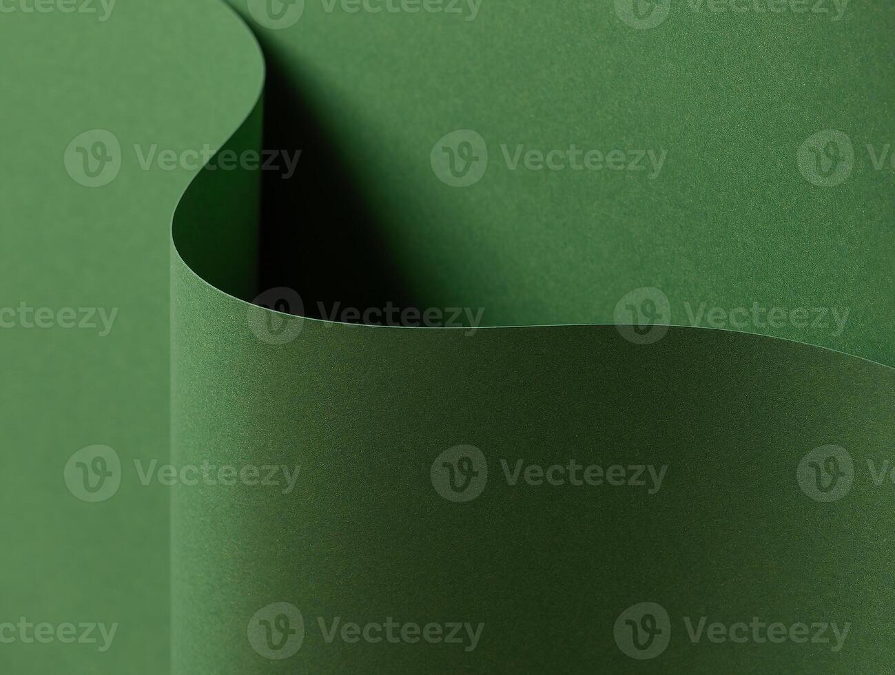 Deep forest green paper background with a smooth matte texture and layered, wavy folds. Rich moss photo