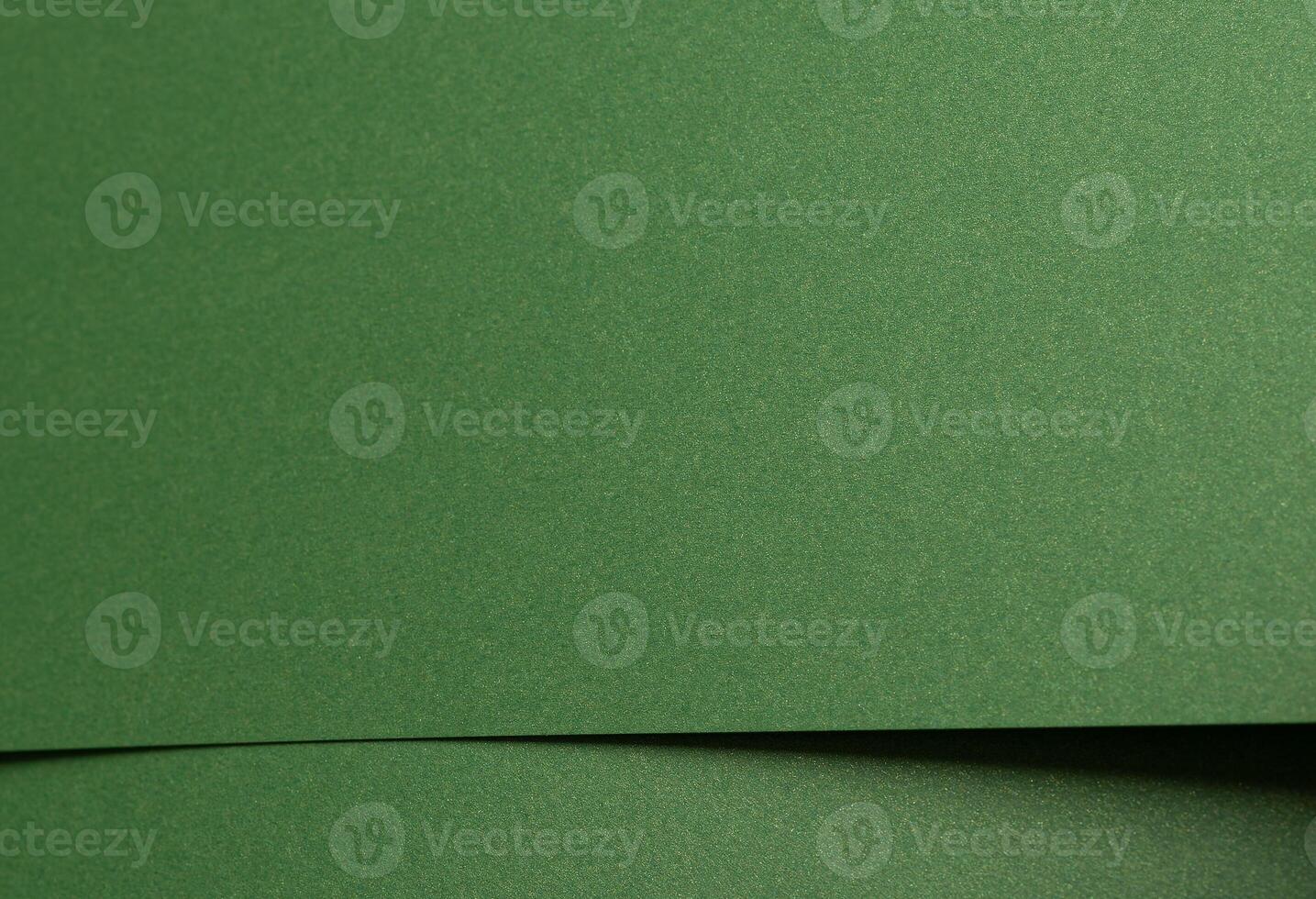 Deep forest green paper background with a smooth matte texture and subtle geometric patterns photo