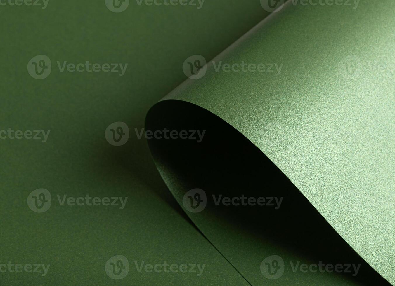 Emerald green paper background with a pearlescent, glossy texture. Deep forest and sage tones create photo
