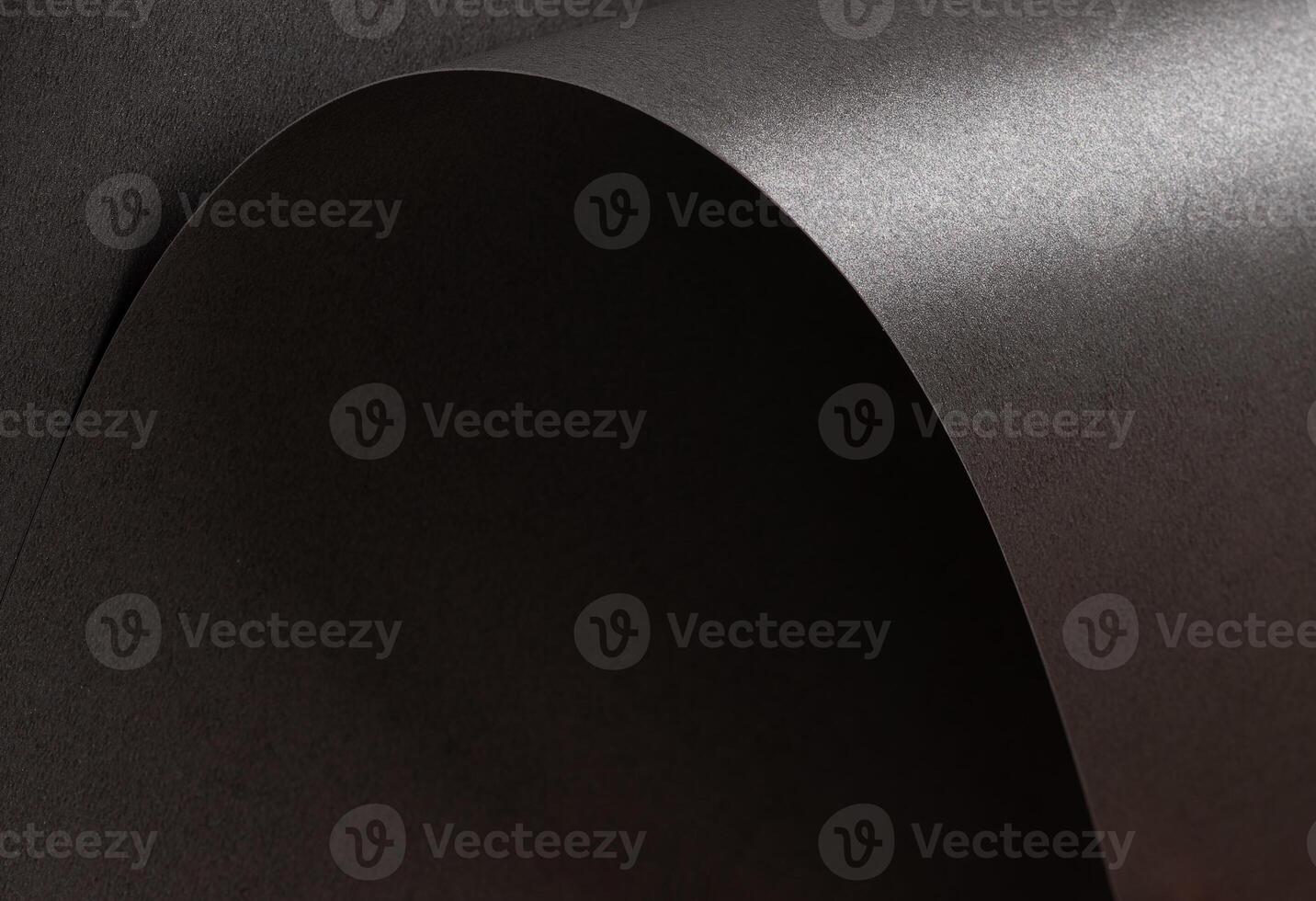 Charcoal gray paper background with a pearlescent, glossy texture. Deep graphite and gunmetal tones photo