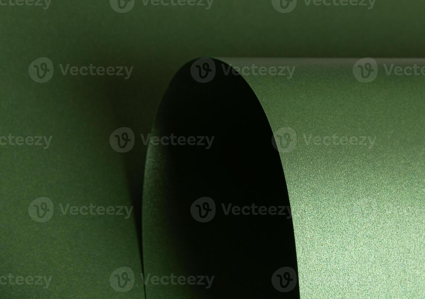 Emerald green paper background with a pearlescent, glossy texture and shimmering wavy edges. elegant photo