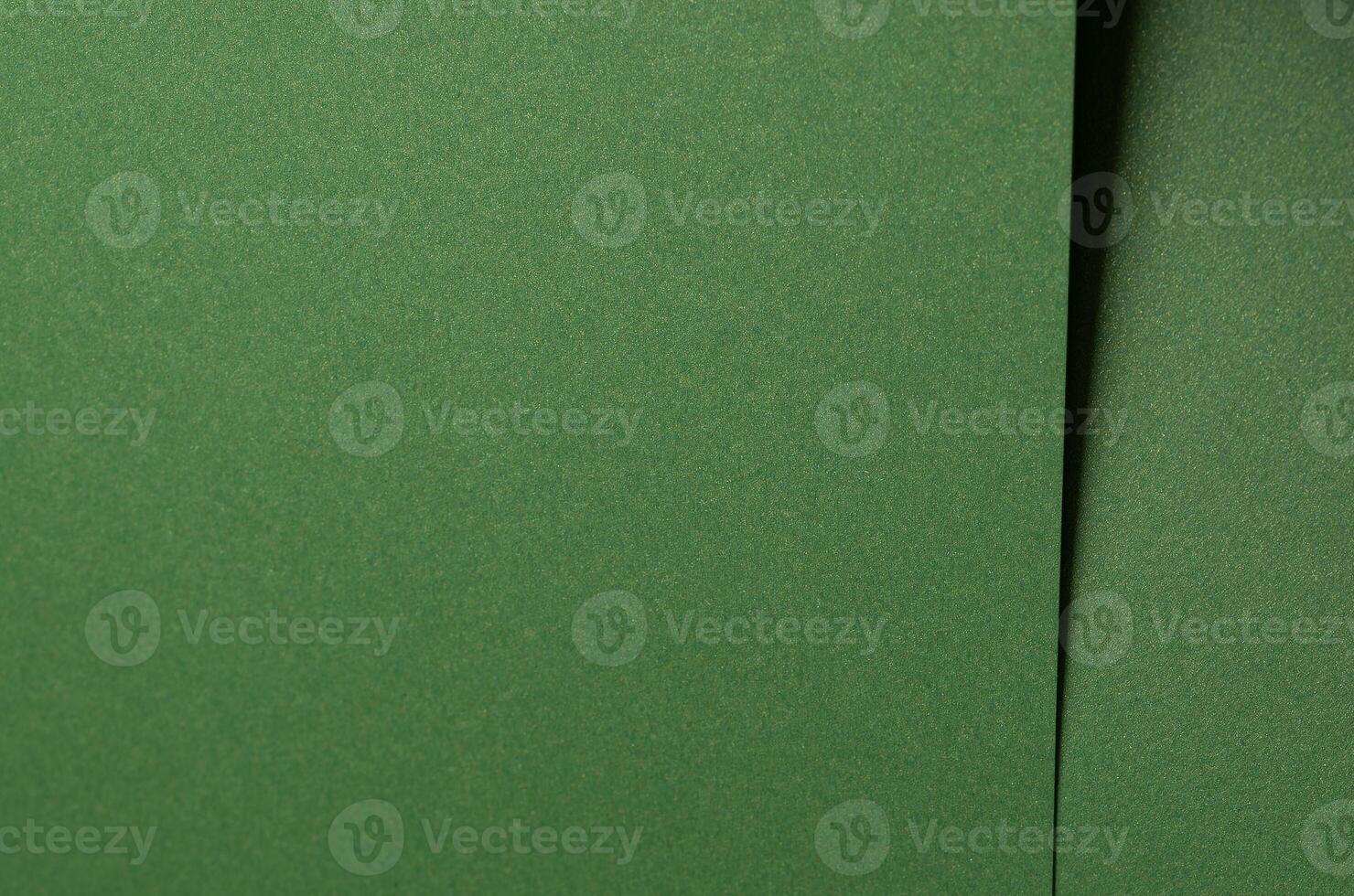 Deep forest green paper background with a smooth matte texture. Rich basil and olive tones create an photo
