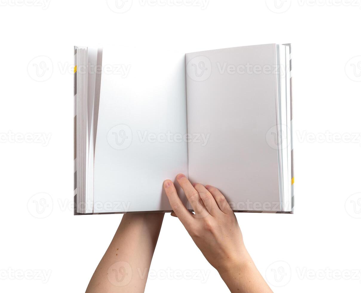 holding an open, blank book or notebook with both hands, showcasing the clean pages for reading or photo