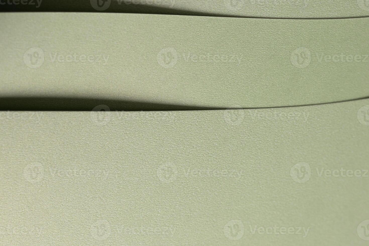Pastel sage green paper background with a soft texture and layered folds. Muted olive and moss tones photo