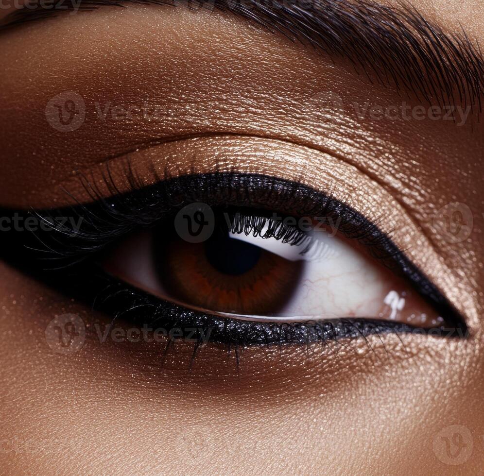 Close-Up of Brown Eye with Dramatic Black Eyeliner and Metallic Gold Eyeshadow photo
