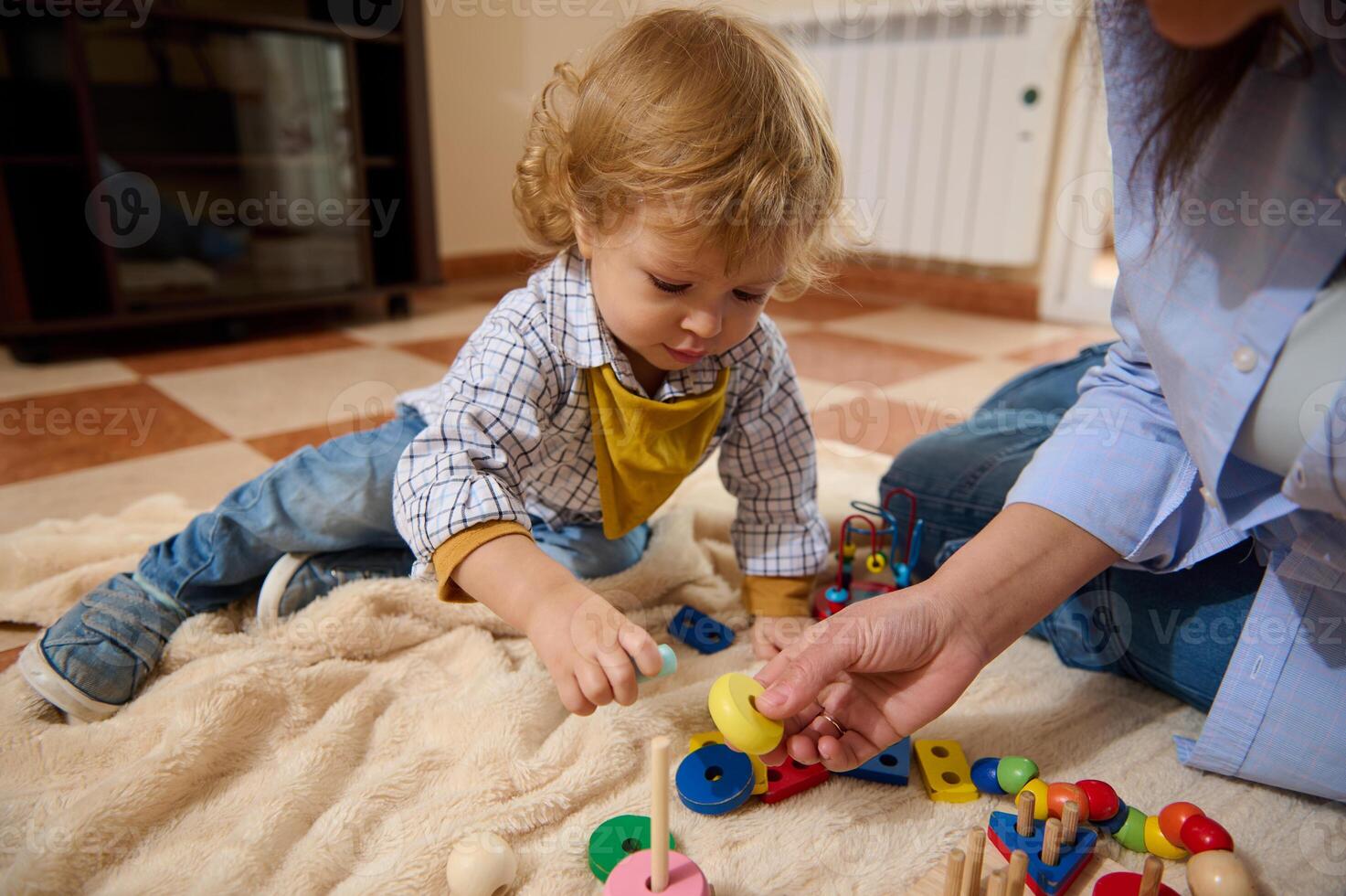 Young Child Playing with Educational Toys on Floor with Parent photo