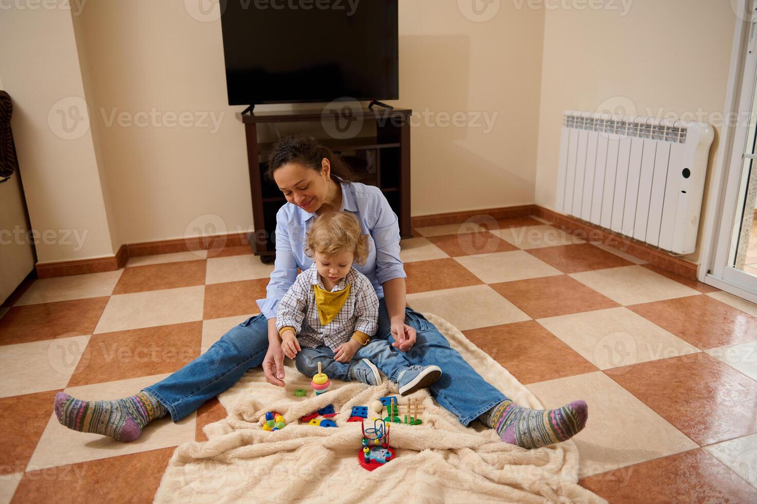 Mother and Child Playing Together at Home with Toys on a Blanket photo