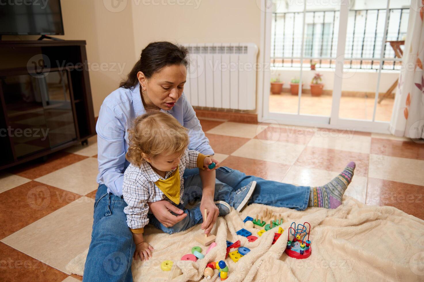 Mother and Child Enjoy Quality Time Together Playing Educational Toys Indoors photo
