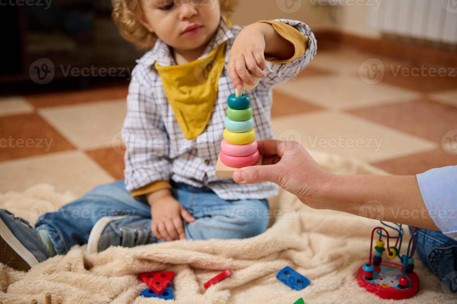 Toddler Playing with Stacking Toy While Receiving Guidance at Home photo