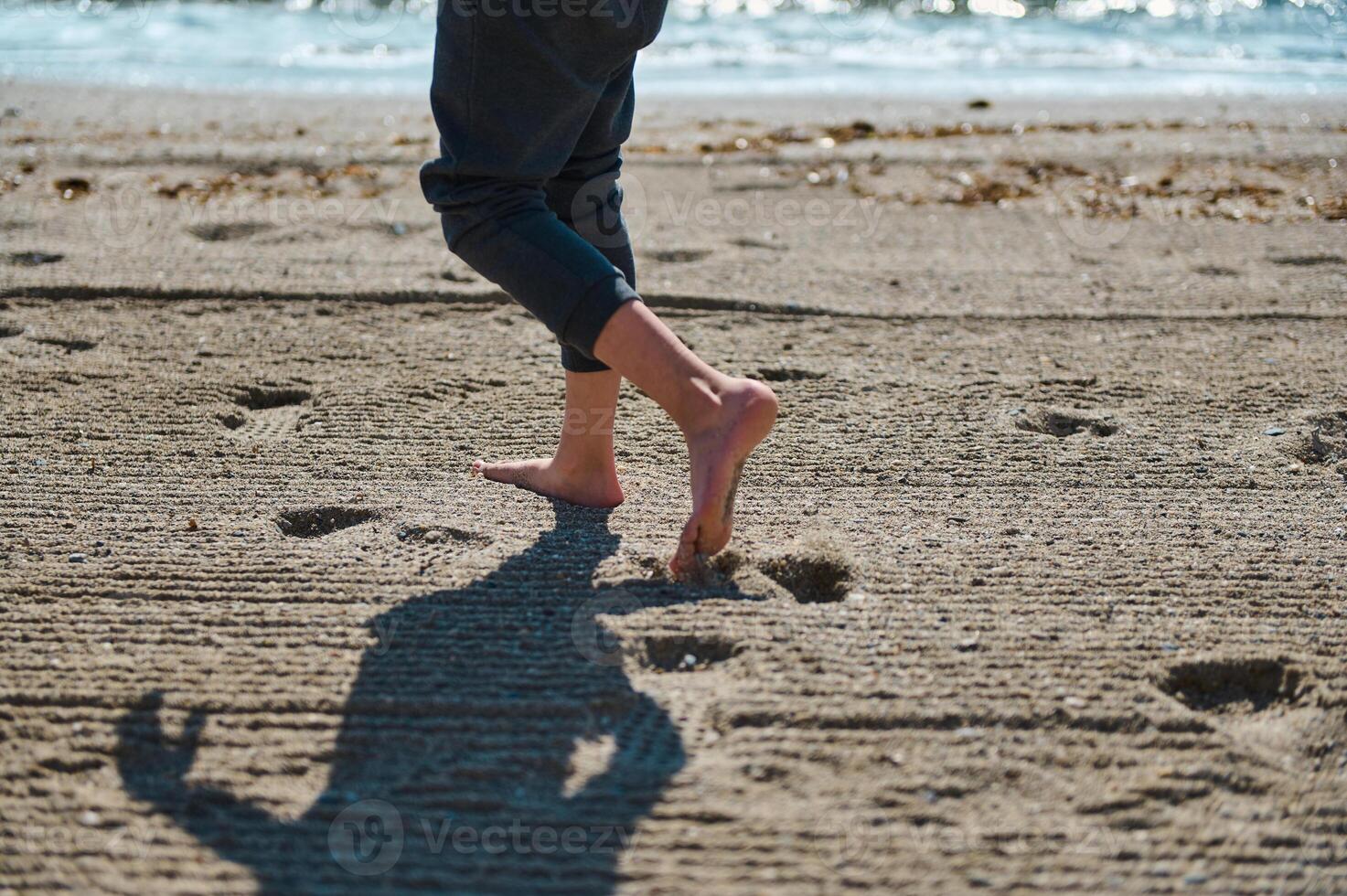 Barefoot Steps on Sunny Beach Appealing to Summer Vibes and Relaxation photo