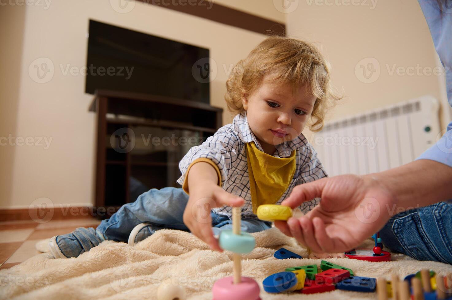Adorable Toddler Engaged in Stacking Activities While Learning Through Play Indoors photo