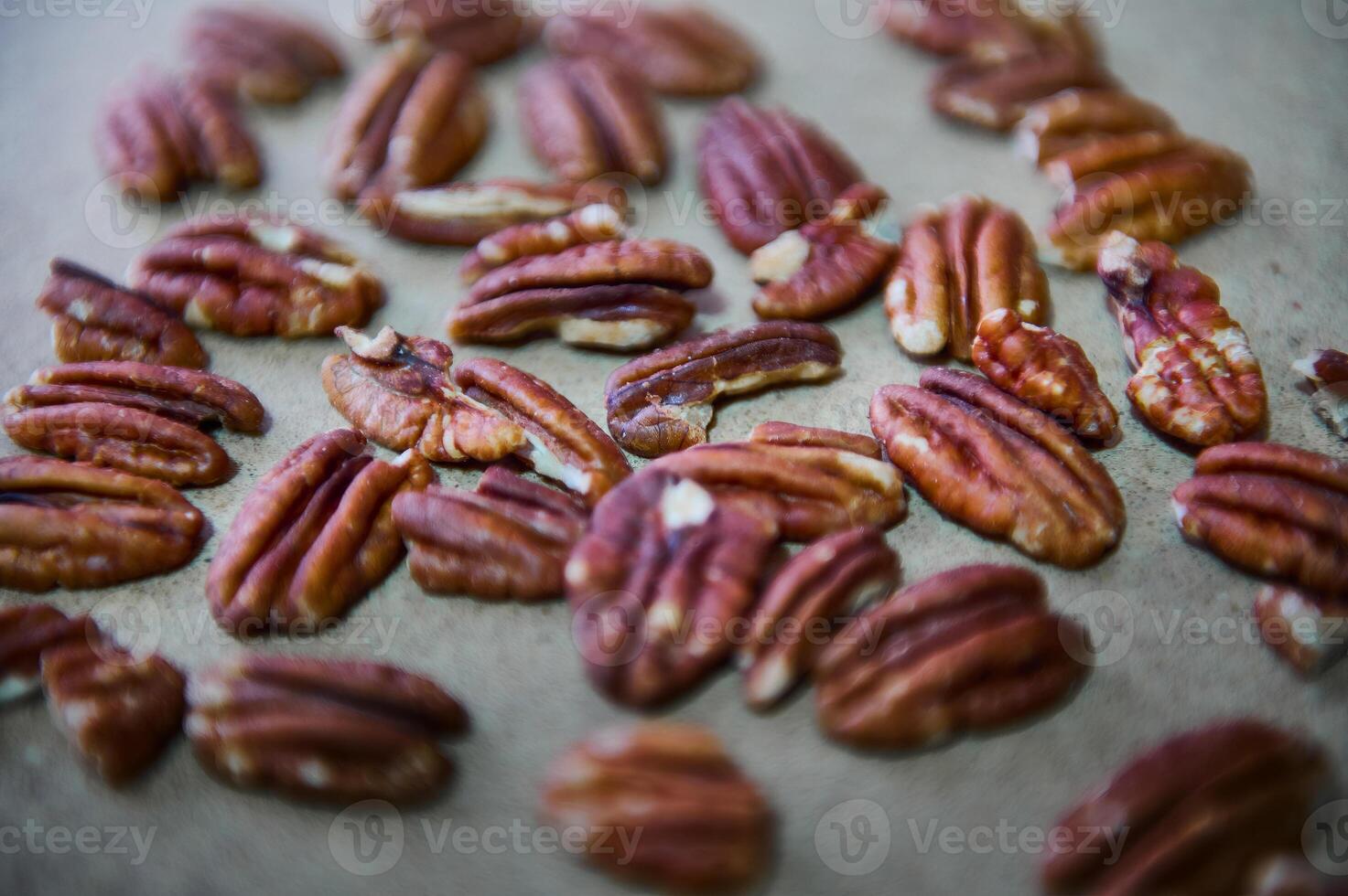 Close-Up of Healthy Pecan Nuts Arranged on a Neutral Background Highlighting their Natural Texture photo