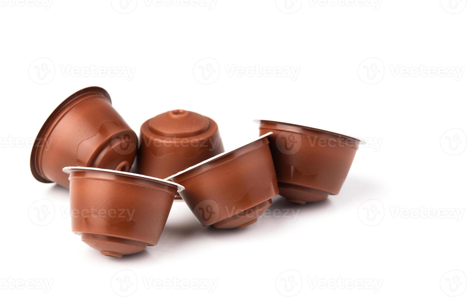 Brown coffee capsules on a white background. Plastic espresso pods for coffee machines. photo
