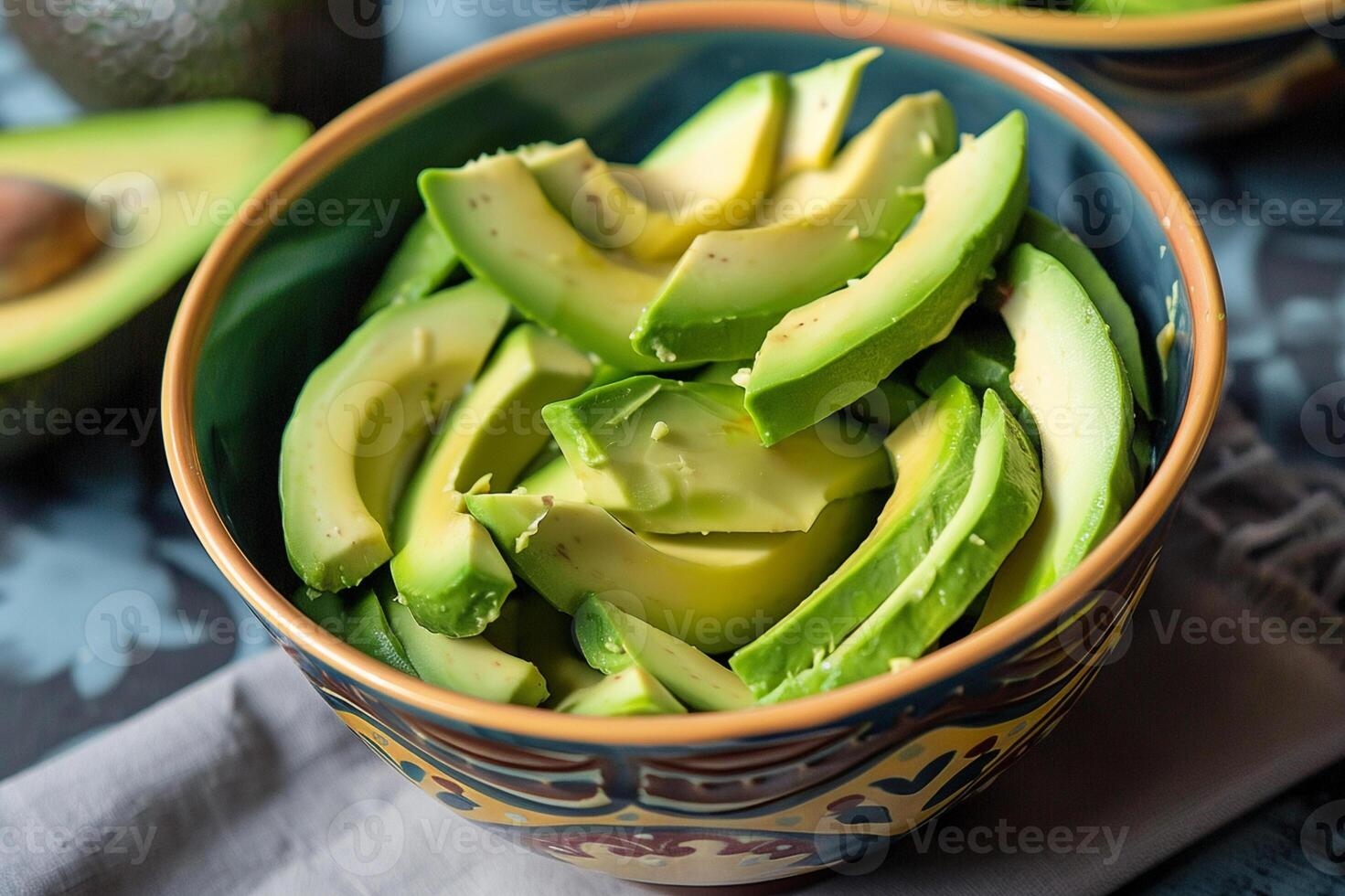 Fresh avocado slices in a bowl, ready to eat. Healthy vegan food, organic ingredient for salads, toast, and guacamole. photo