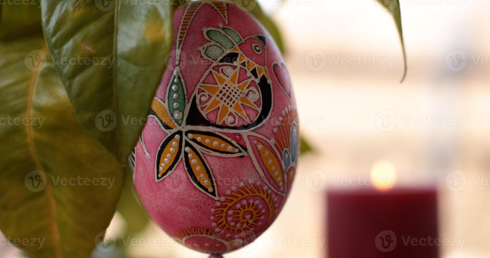 Easter decorations featuring handcrafted Easter egg dot art pysanka with vibrant colors and intricate designs displayed against a warm background photo