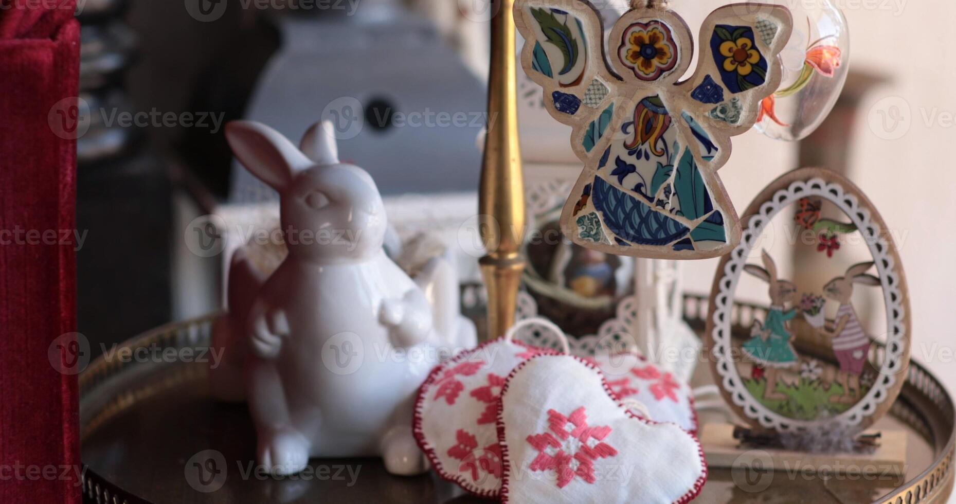 Easter decorations displayed on a table with handcrafted items and a white bunny sculpture creating a festive atmosphere photo