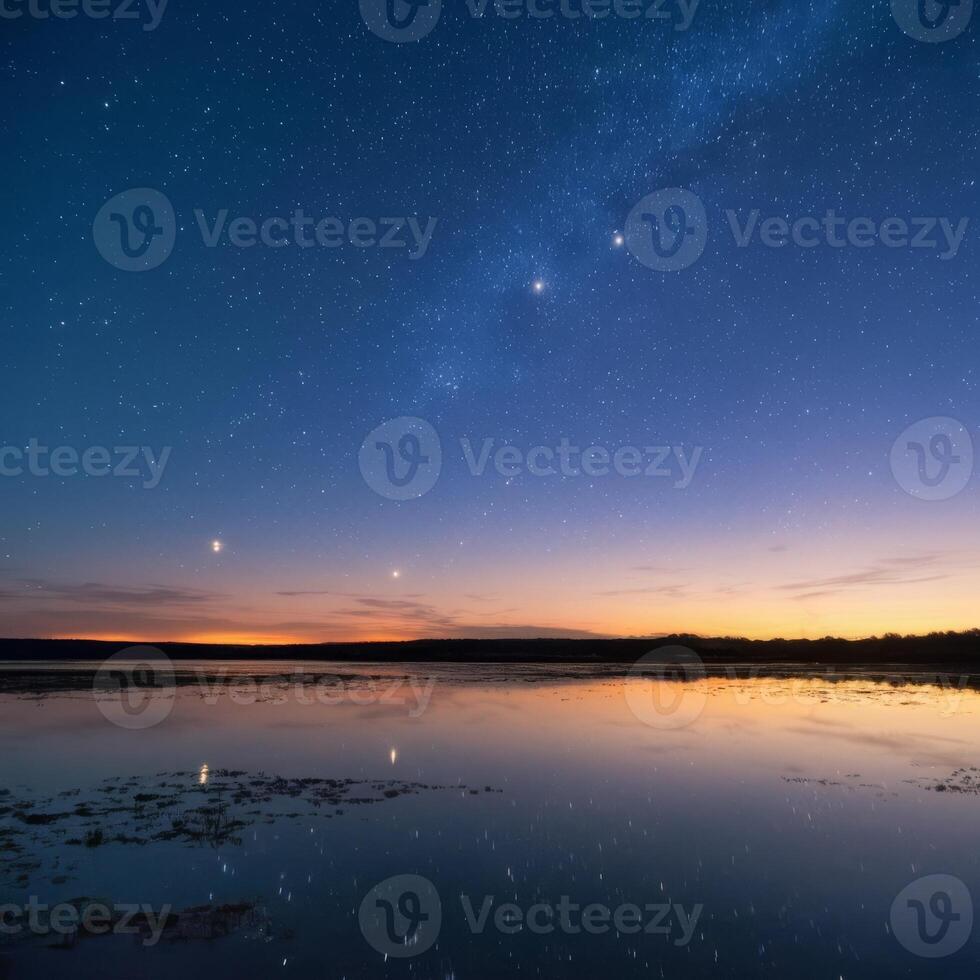 The milky way and venus over a lake photo