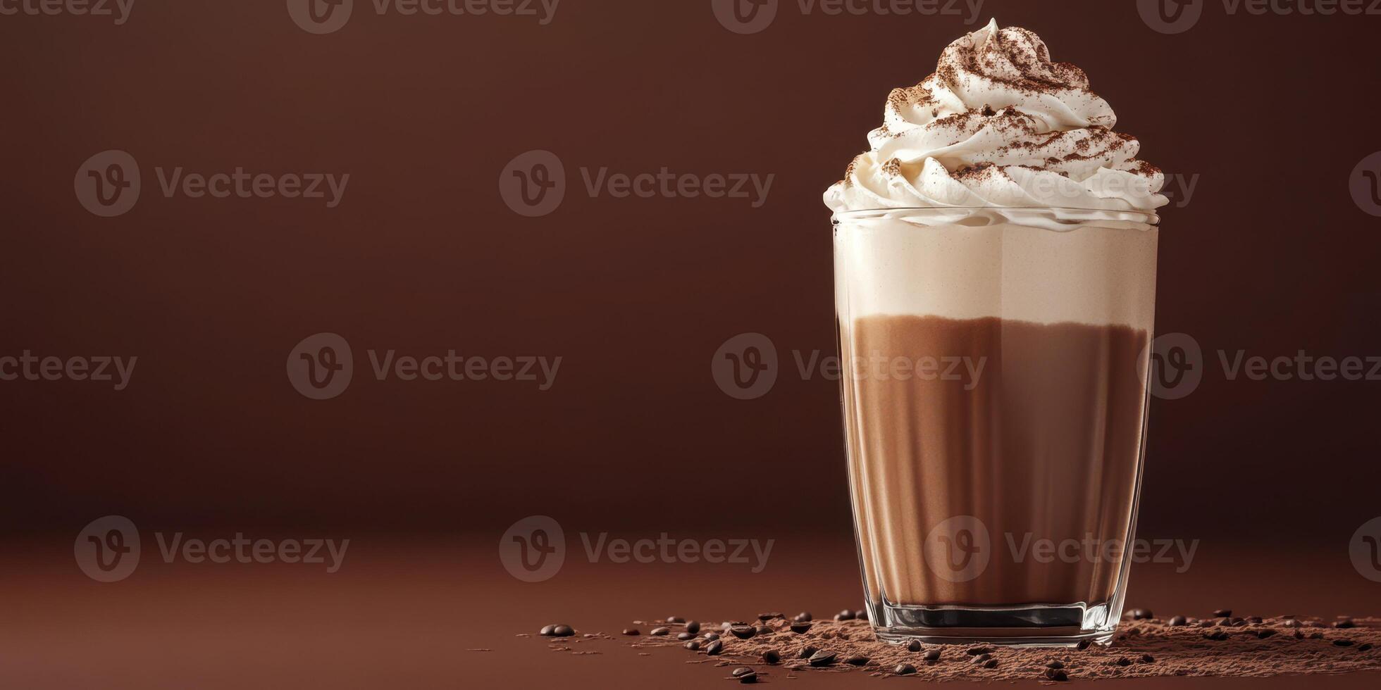 Creamy chocolate shake topped with whipped cream and cocoa in a glass on a brown background photo