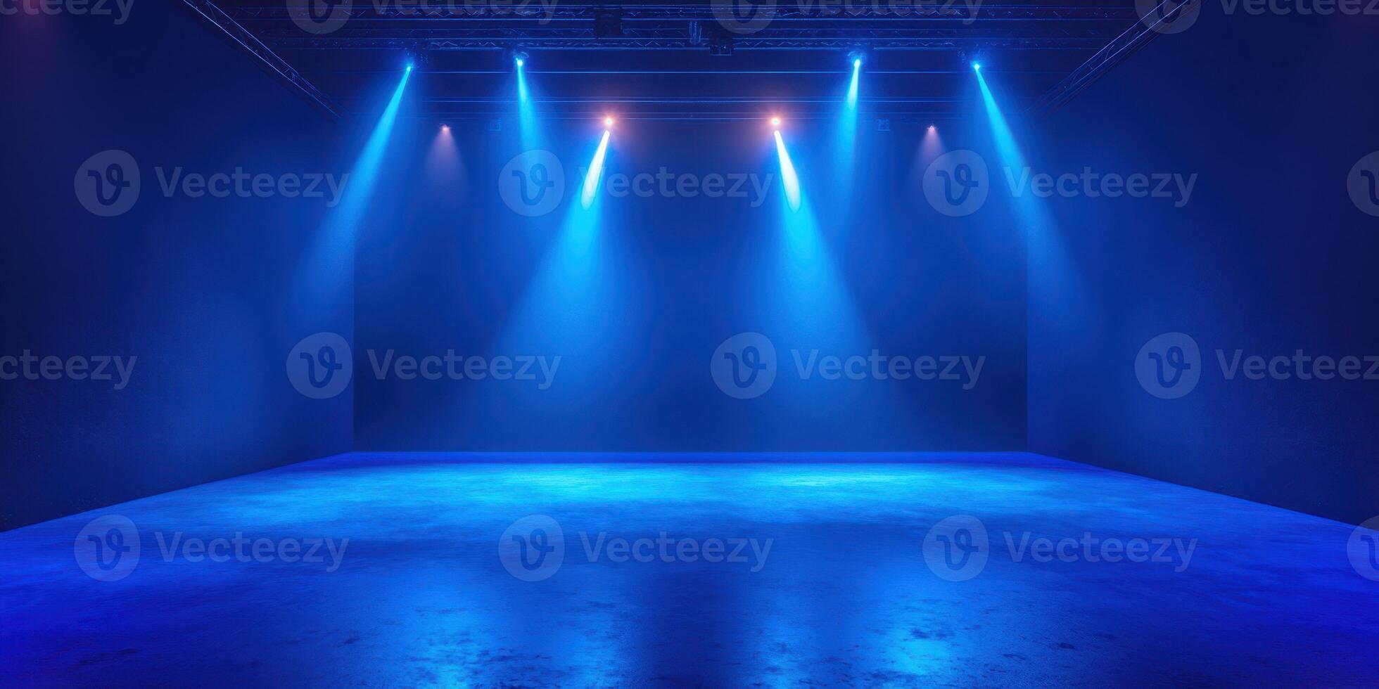 Bright blue stage lights illuminate an empty performance space ready for an exciting event in the evening photo