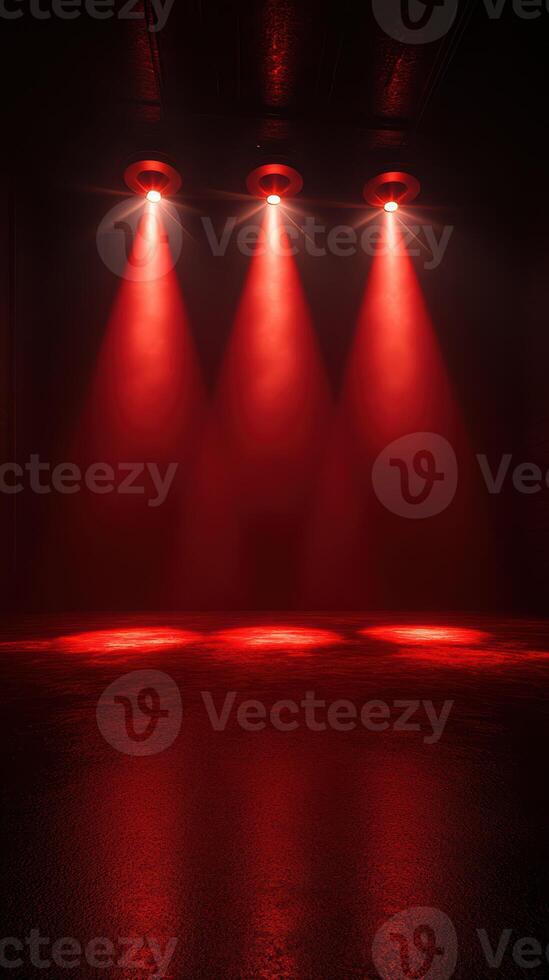 Red spotlight beams illuminate a darkened indoor space creating dramatic shadows and atmosphere for an event photo