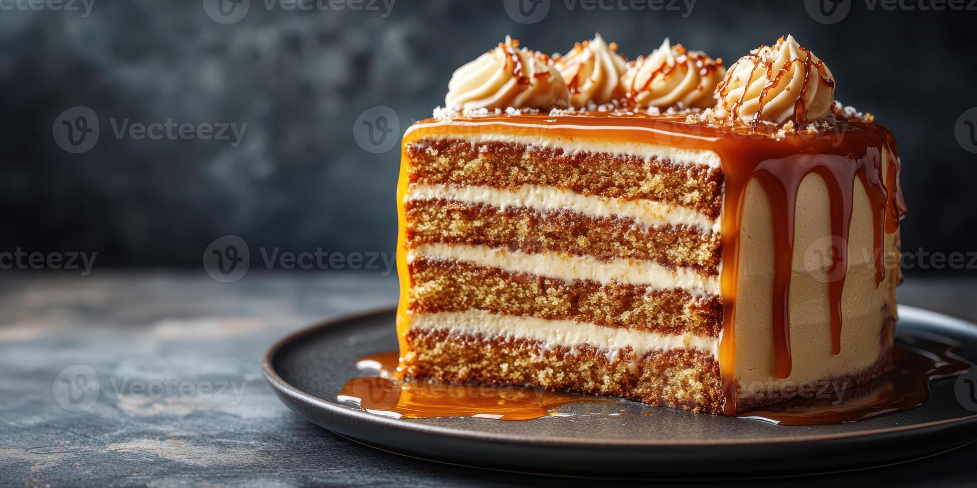 Delicious layered caramel cake with creamy frosting served on a dark plate in a cozy dessert setting photo