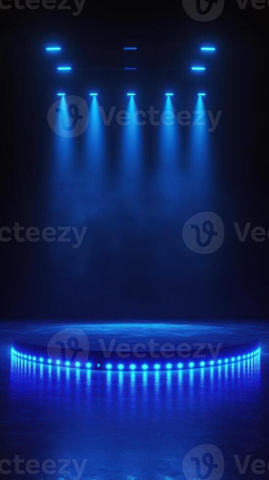 Bright blue lights illuminate a circular stage in a darkened venue, creating an atmosphere ready for a performance photo