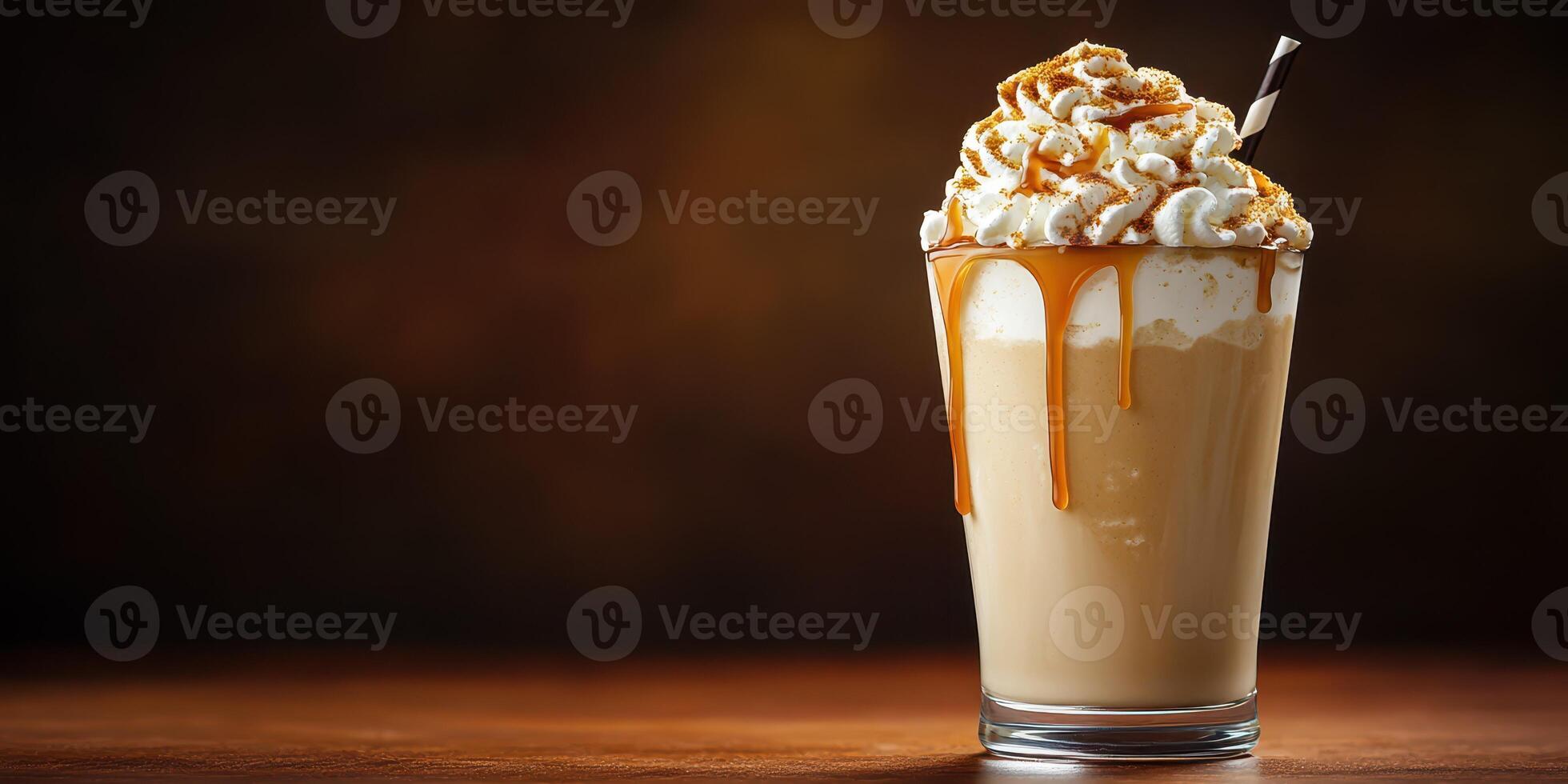 Delicious creamy dessert drink topped with caramel syrup and whipped cream served in a tall glass on a wooden table at a cozy cafe photo