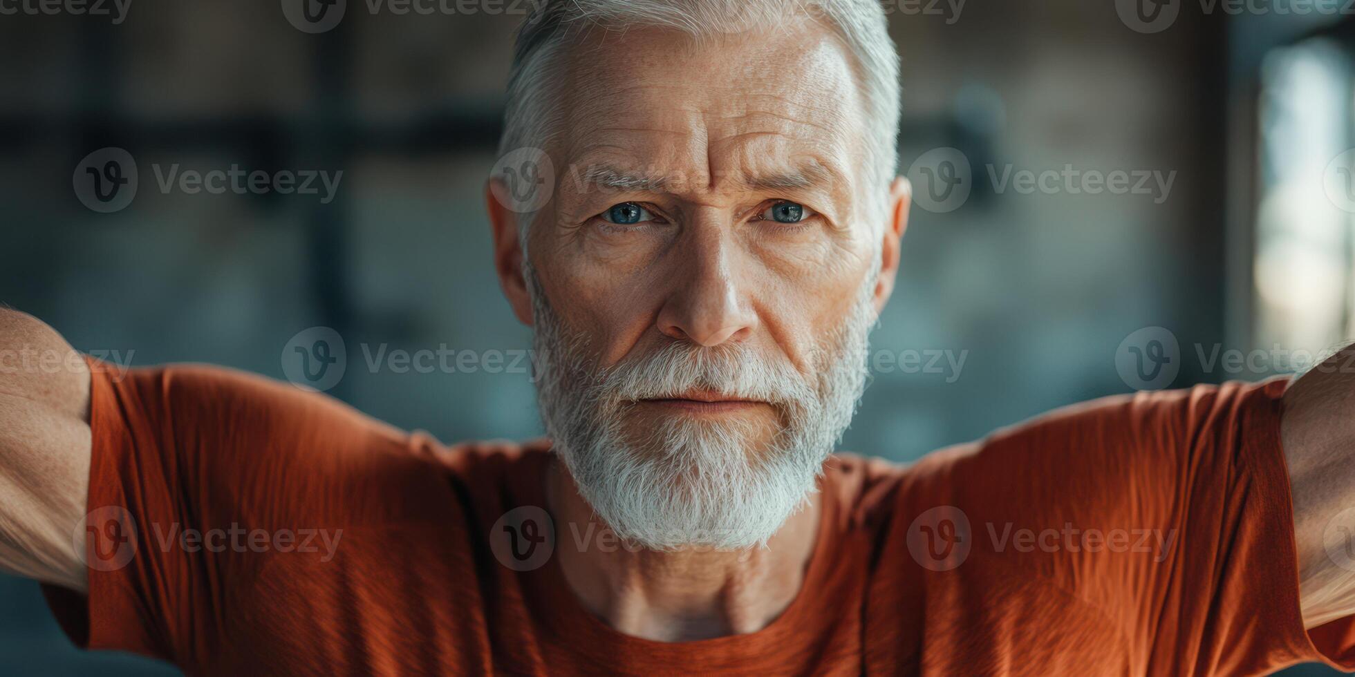 Older man focuses intensely while exercising in a gym during the morning hours for strength training and overall fitness photo