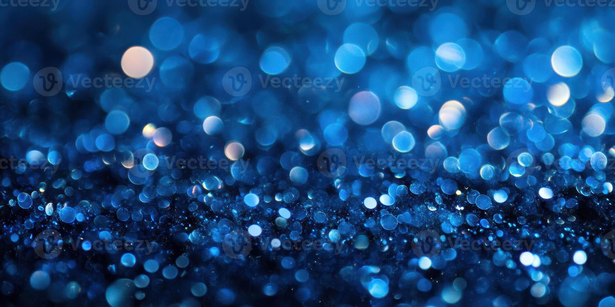 Shimmering blue bokeh effect created by light reflecting off tiny particles during a nighttime setting photo