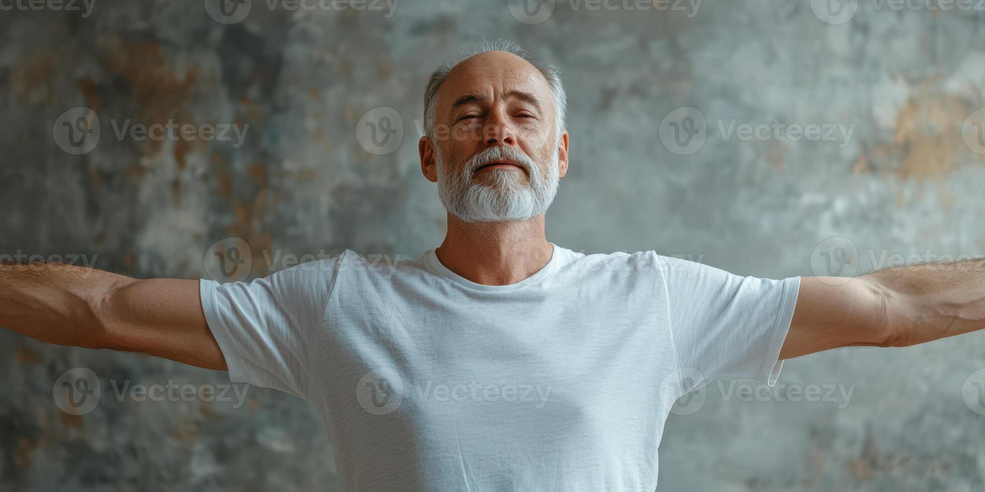 Elderly man with gray beard enjoying a moment of peace with arms extended in a tranquil indoor setting photo
