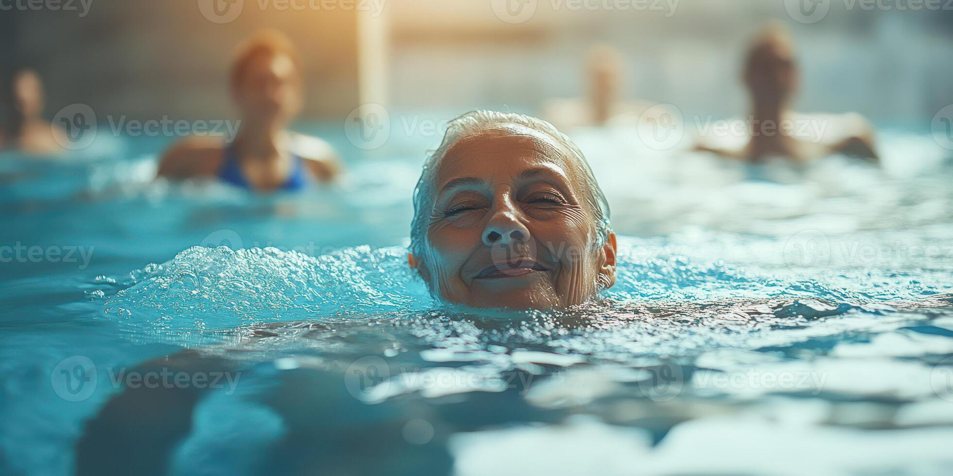 Swimming class for seniors encouraging physical activity in a bright indoor pool setting during the day photo