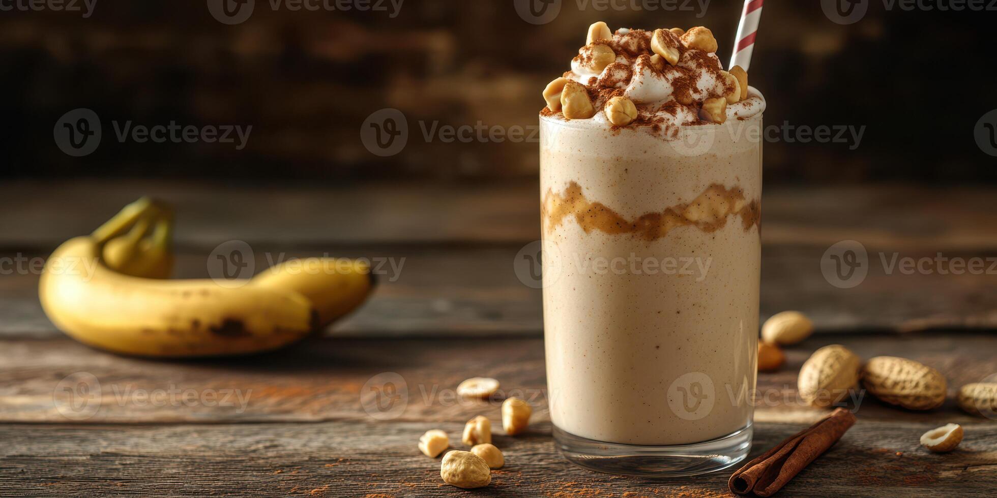 Delicious peanut butter banana smoothie served in a tall glass with whipped cream and nuts photo