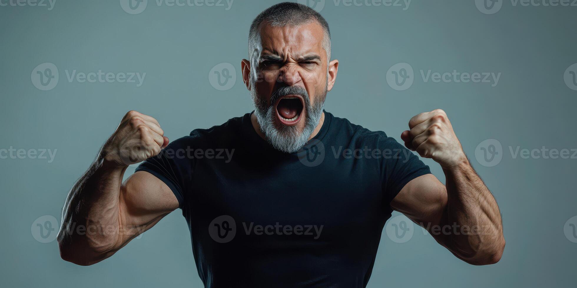 Muscular man expressing intense emotion during fitness session in studio photo