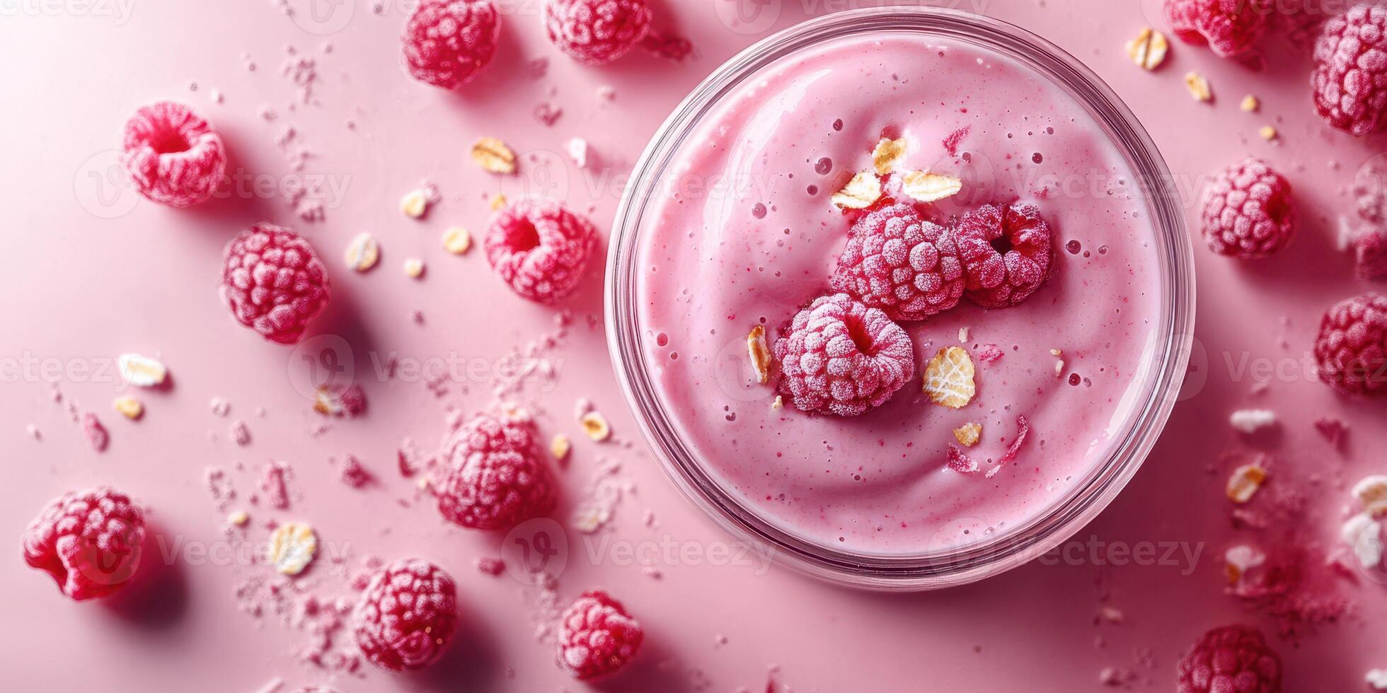 Delicious raspberry smoothie served in a glass bowl with fresh berries and oats on a pink background photo