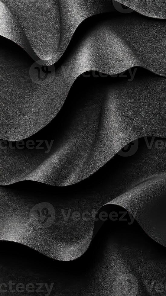 Layers of black textured fabric create a mesmerizing wave pattern in soft light, showcasing rich depth and elegance in design photo