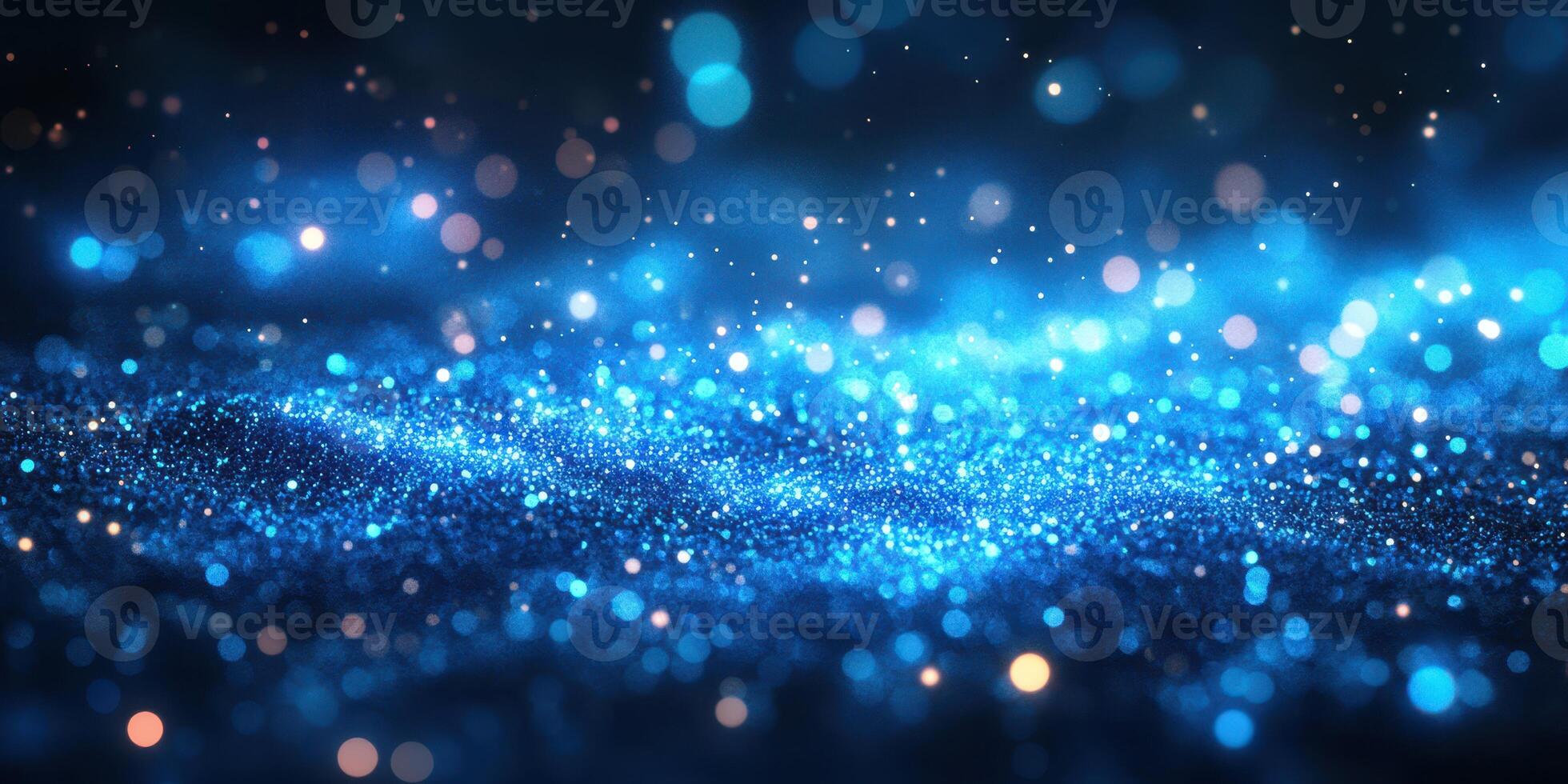Sparkling blue particles create a mesmerizing effect in a dark setting during an artistic display of light photo