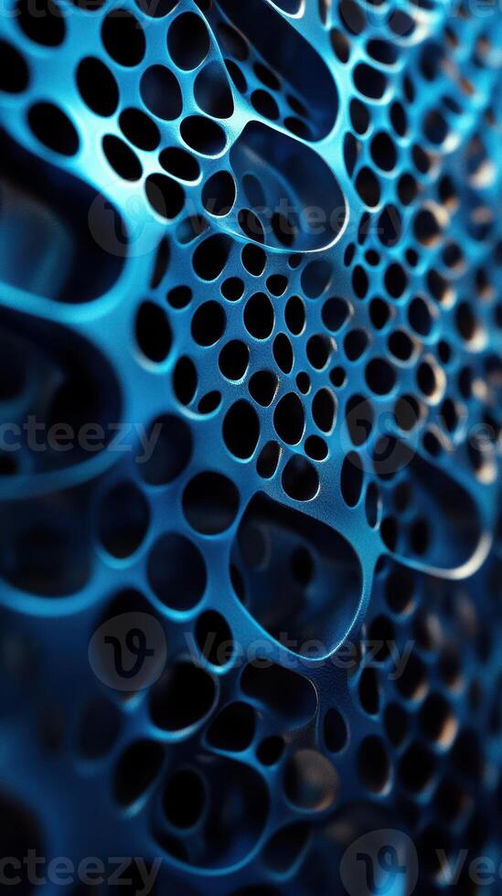 Intricate blue metallic texture showcasing complex patterns of holes and curves in a close-up view photo