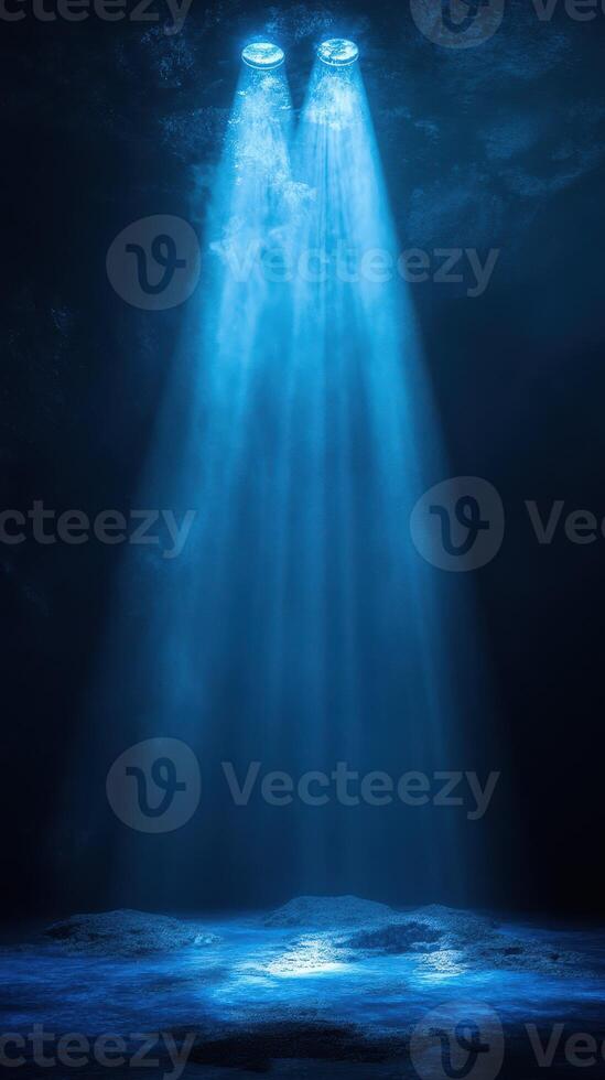Bright blue lights shining down into a dark cavern creating an ethereal atmosphere underwater photo