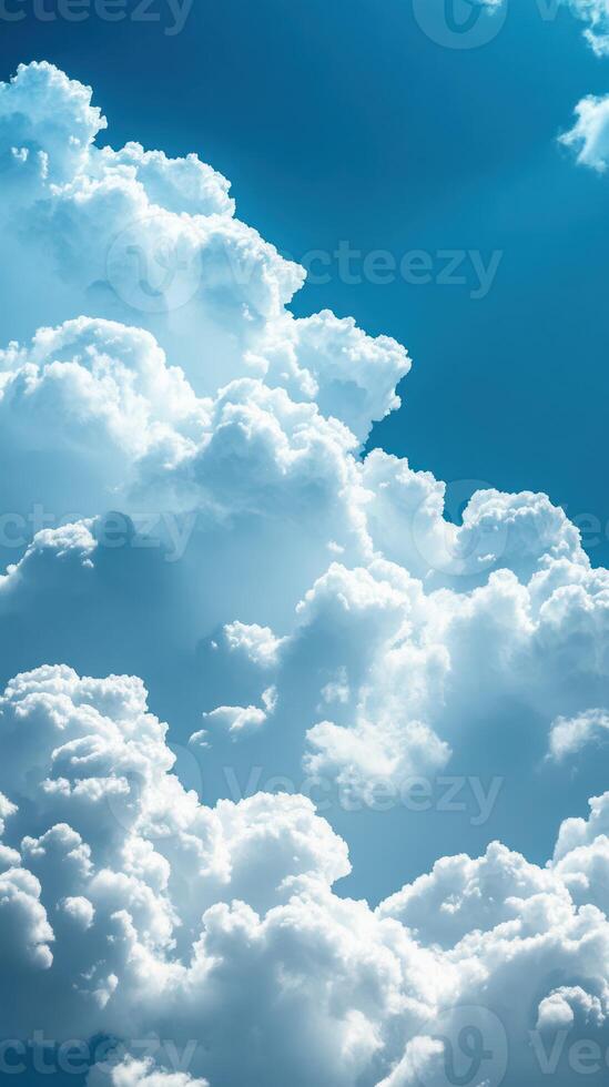 Bright white clouds billow against a vivid blue sky during a sunny afternoon photo