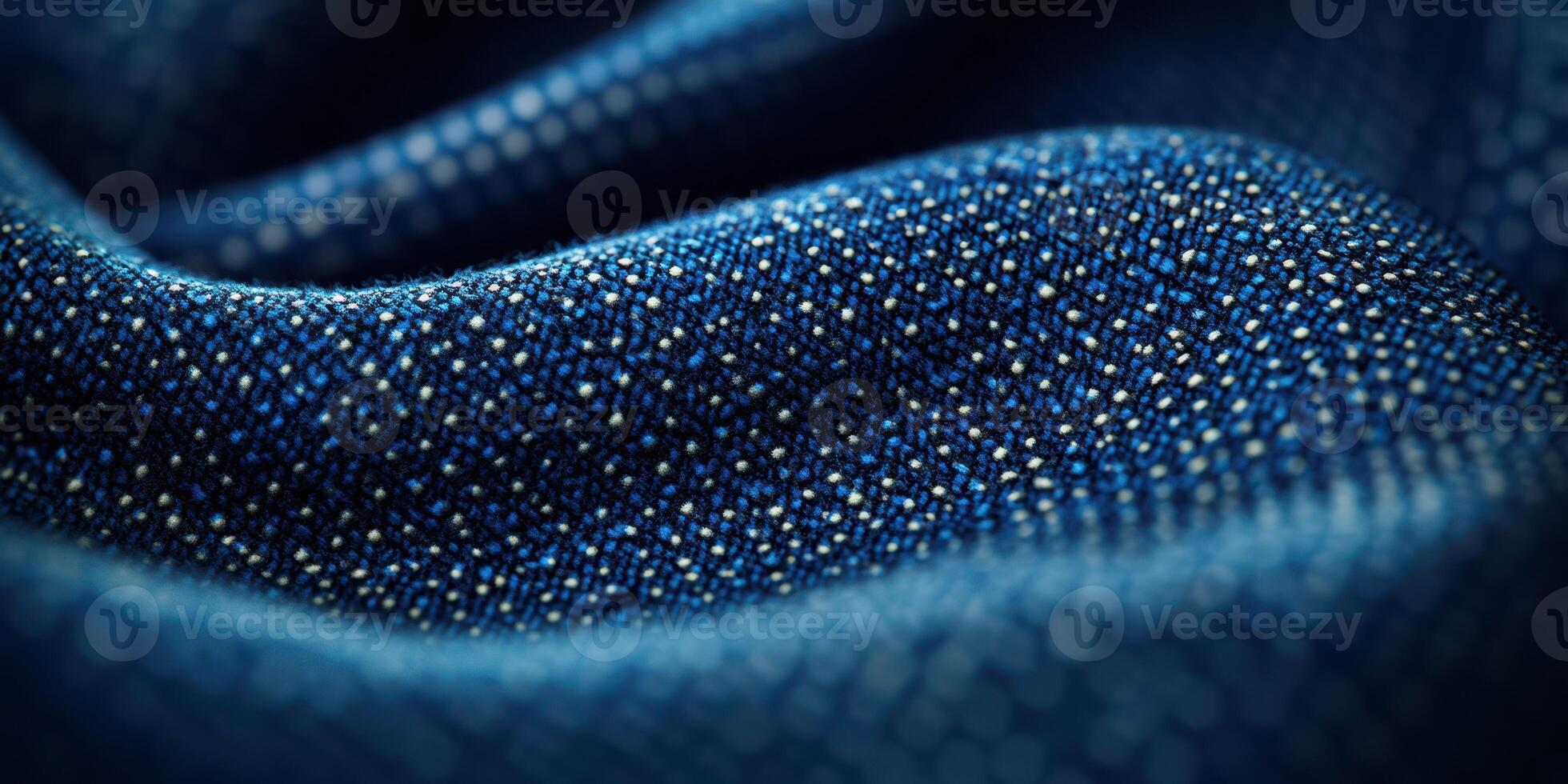 Close-up view of textured blue fabric showcasing intricate weaving patterns and shimmering details under soft light photo