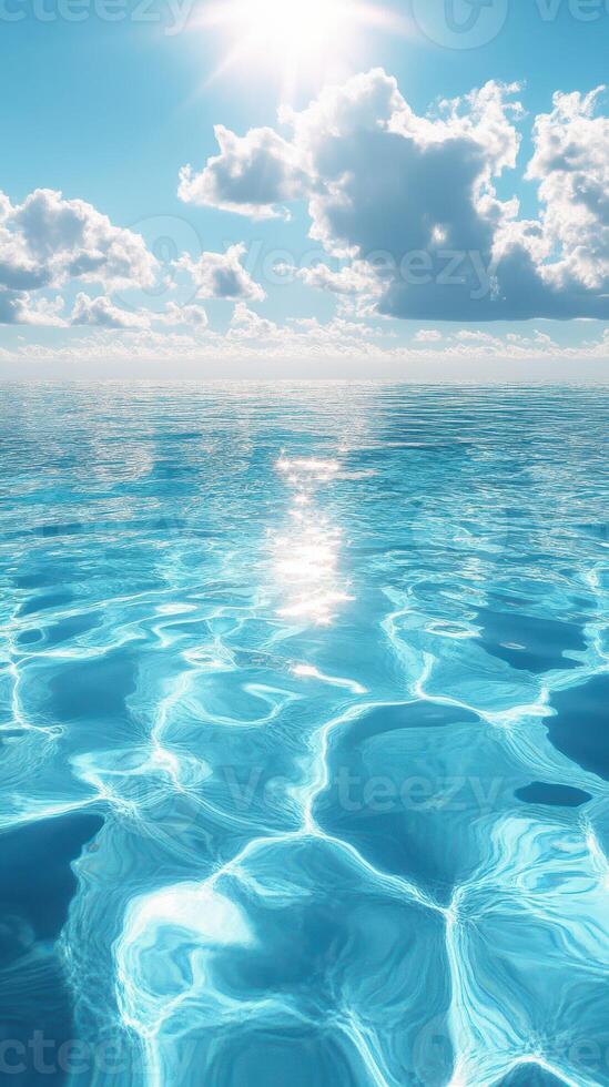 Bright sunlight reflects on calm turquoise ocean waves under a blue sky with fluffy clouds photo