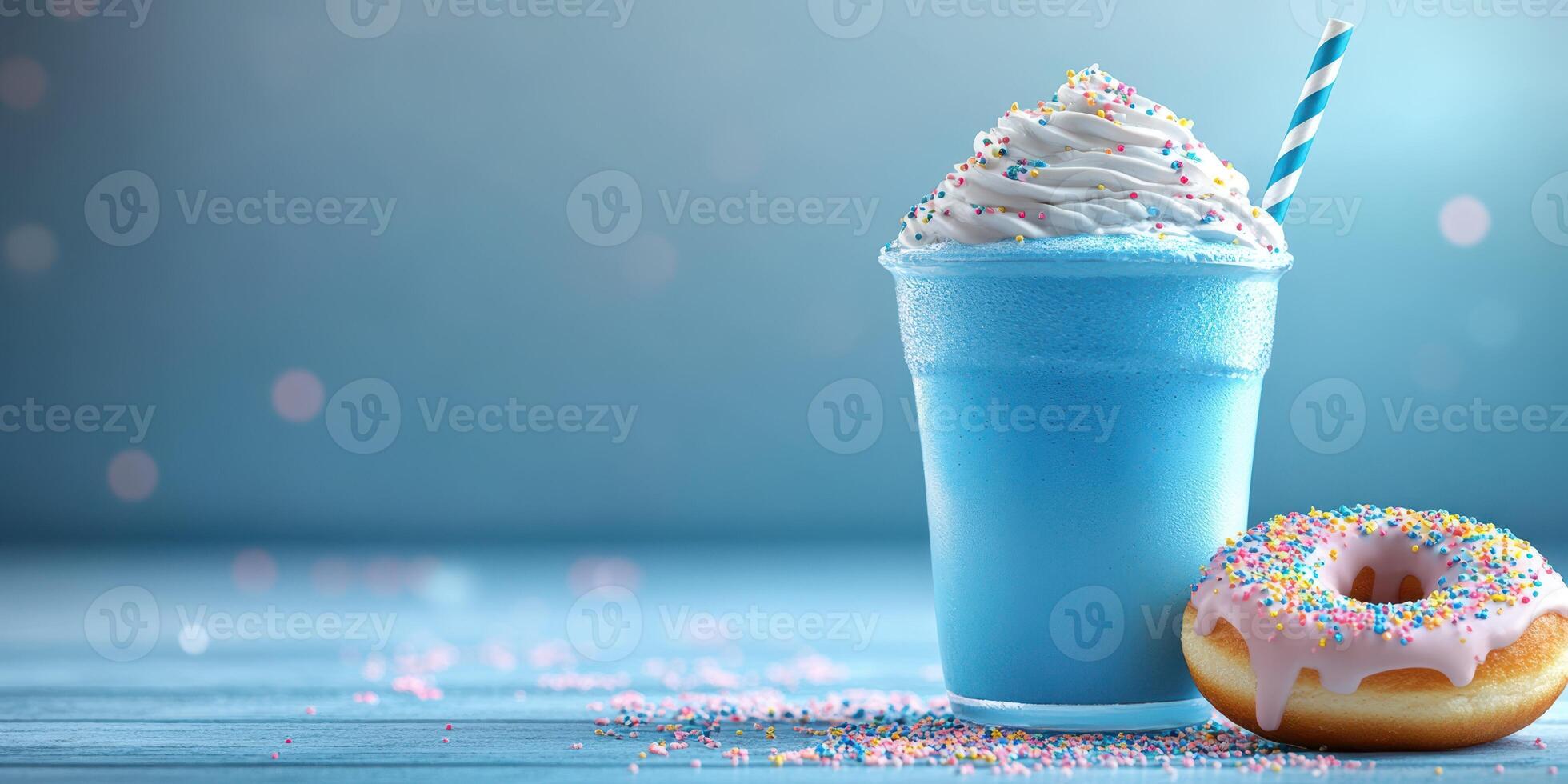 Refreshing blue drink with whipped cream and colorful donut on a light blue wooden table photo