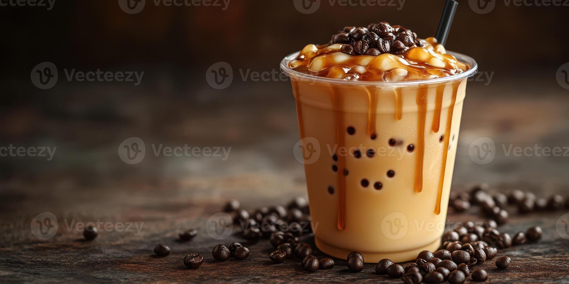 Iced coffee drink with caramel drizzle and coffee beans on a dark wooden surface photo
