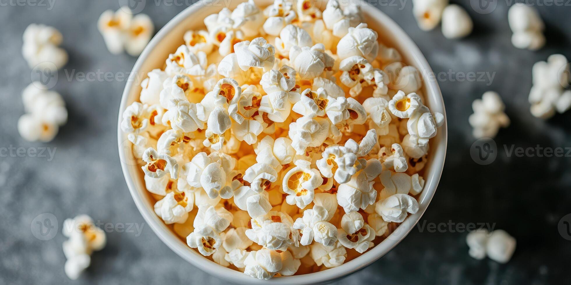 Freshly popped popcorn in a large bowl on a textured surface, perfect for movie nights and gatherings photo