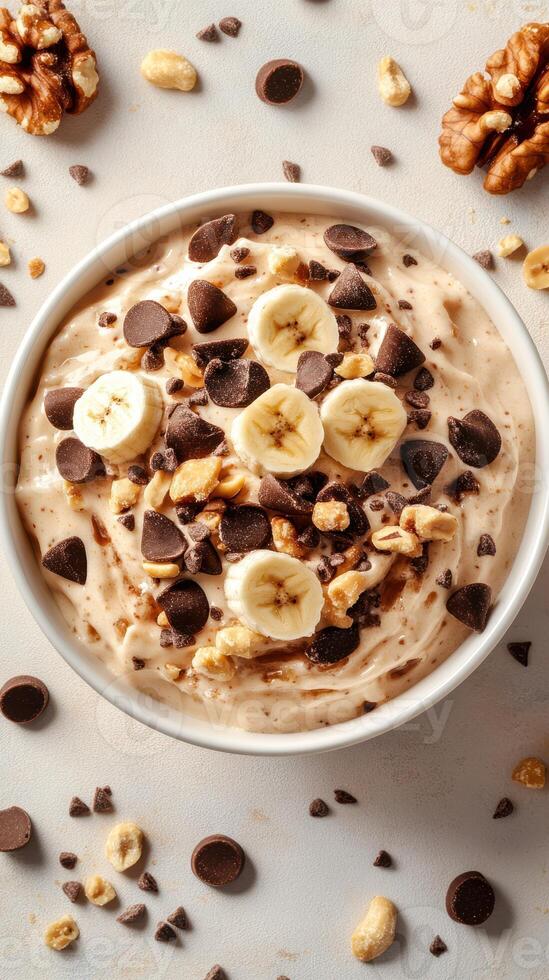 Creamy banana dessert with chocolate chips and walnuts prepared in a kitchen setting photo
