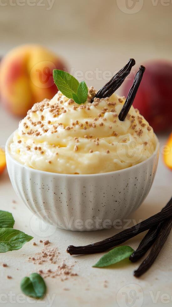 Creamy dessert topped with vanilla pods and mint leaves, featuring fresh peach slices in the background photo