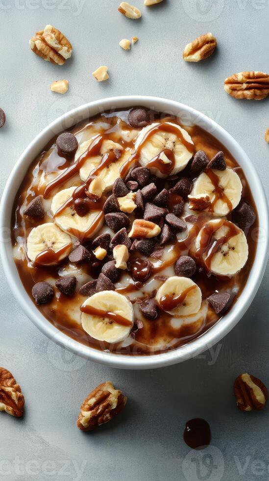 Delicious bowl of chocolate banana oatmeal topped with nuts and chocolate chips in a cozy kitchen setting photo