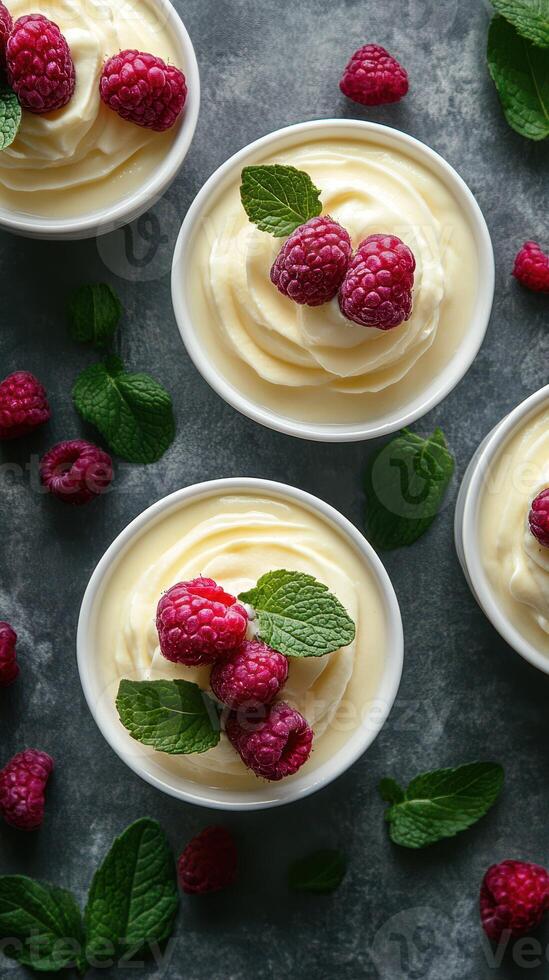 Delightful raspberry dessert served in bowls with fresh mint leaves on a textured surface photo